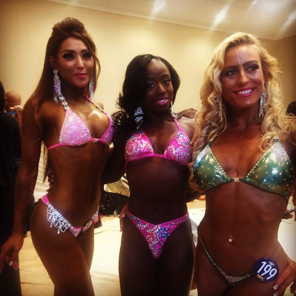 wasidah francois poses with two other female body builders during a competition